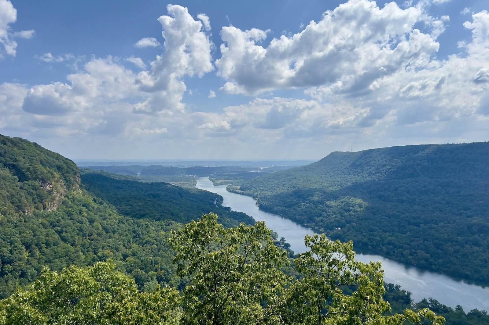 A river winding through a forested valley between steep ridges